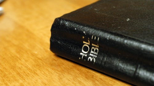 A Bible laying on a table.