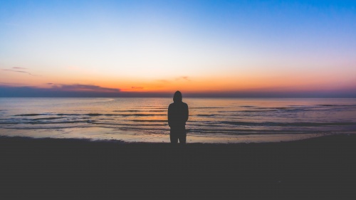 A person looking out over a body of water.