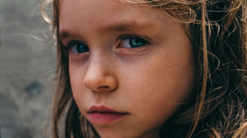 A young girl looking sad.