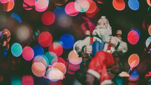 A Santa Claus ornament in a Christmas tree.