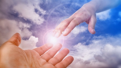 A photo illustration of hand coming out of the clouds.