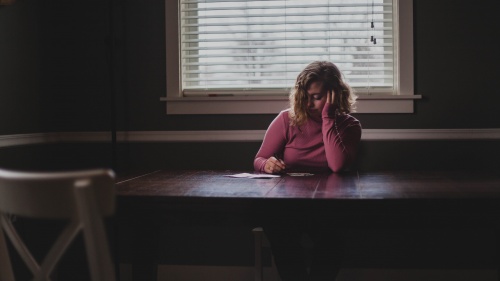 A woman sitting a table.