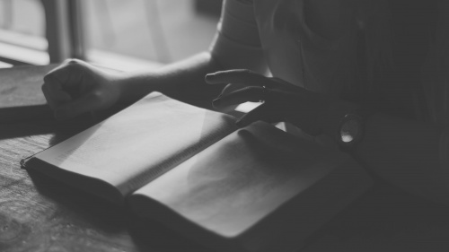 A woman reading a Bible.