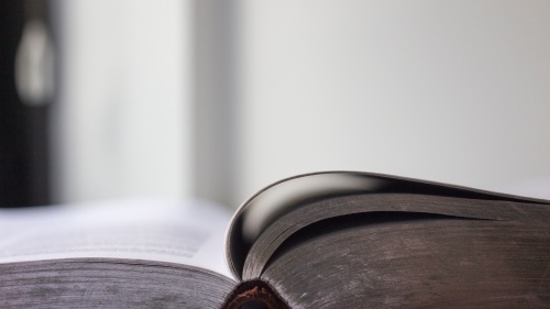 An open Bible laying on a table.