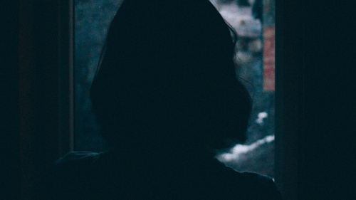 A woman looking out a window.