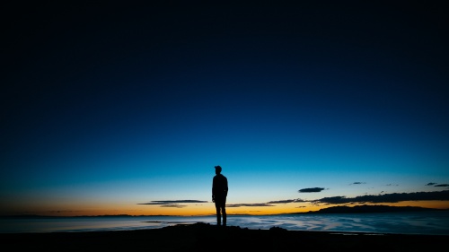 The silhouette of man as the sun sets.