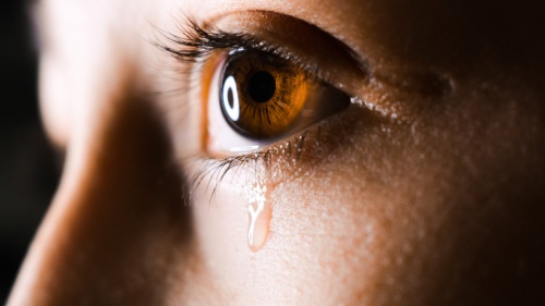 A tear dripping from a person's eye.