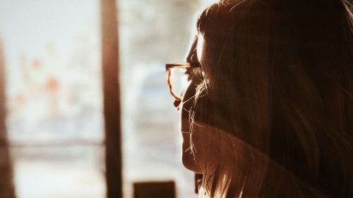 A woman looking out a window.