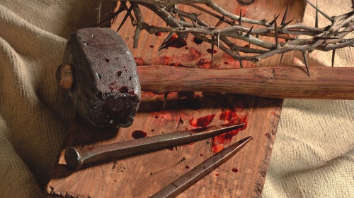 Old hammer, nails and thorns.