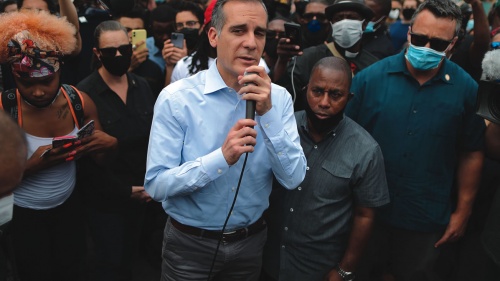 A man speaking to a large crowd.