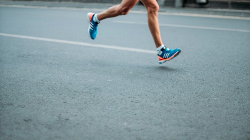 You Can Be a Successful Runner, a cropped image of a man's legs running on pavement