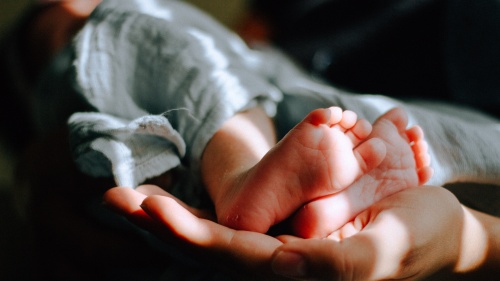 Tiny newborn baby feet.