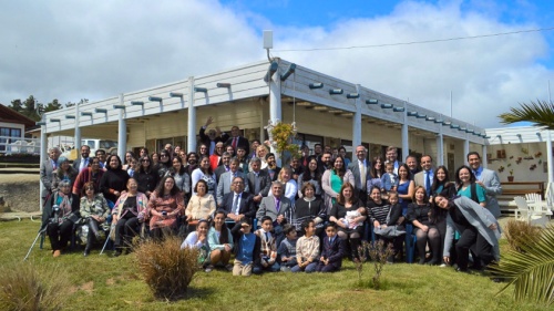 a group of people gathered outside a white building