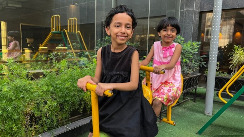 two children enjoying playground equipment