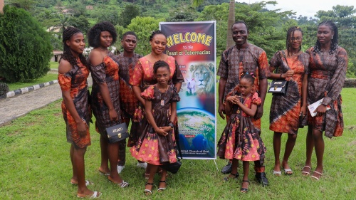 a group of people standing outdoors in front of a banner and wearing coordinating clothing