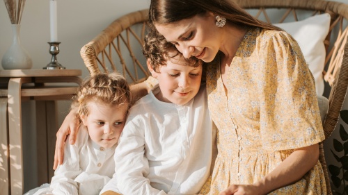 a woman reading to two children