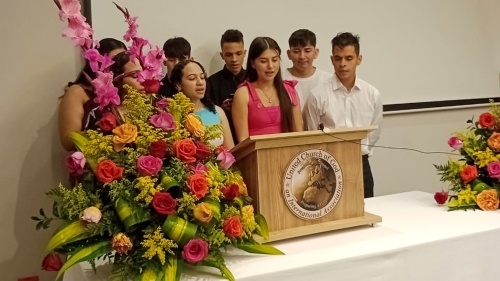 a group of people standing at the lectern to sing