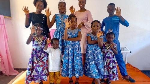 a group of children waving