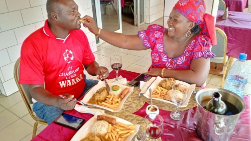 a woman giving a man a spoonful of food