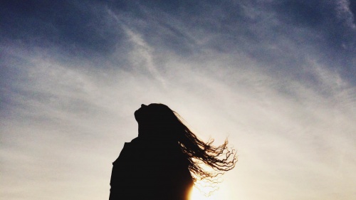 A woman looking up to the sky.