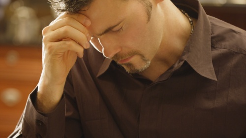 A man praying over his Bible