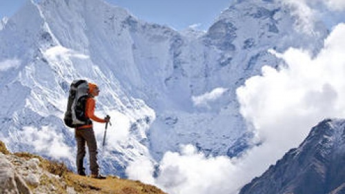 A hiker on top of a mountain pass.