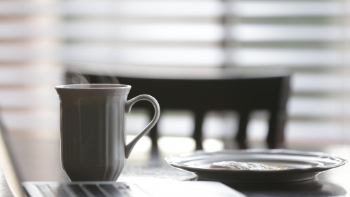 Coffee cup and plate on a table.