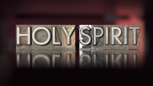 Wood letterpress blocks that spell the word "Holy Spirit".