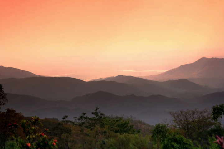 rolling hills with an orange sky in the background