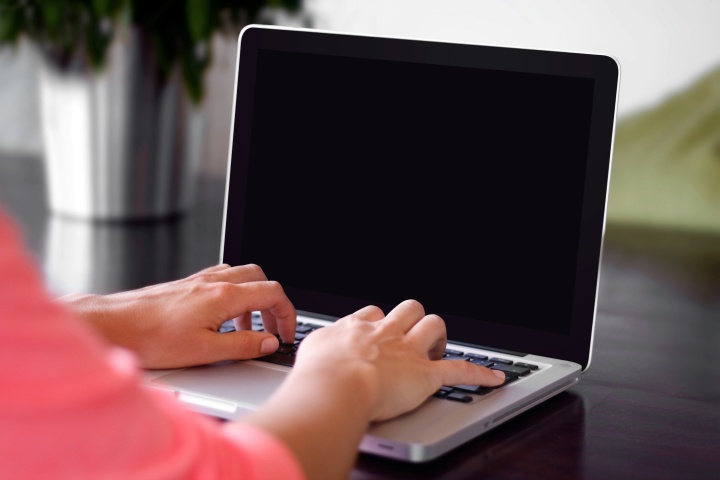 a pair of hands at a laptop