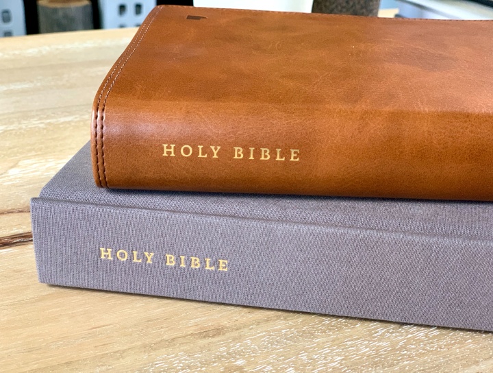 Two Bibles stacked on a table
