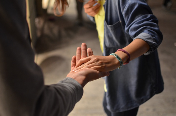 two people standing with one person's hand in the other's outstretched palm