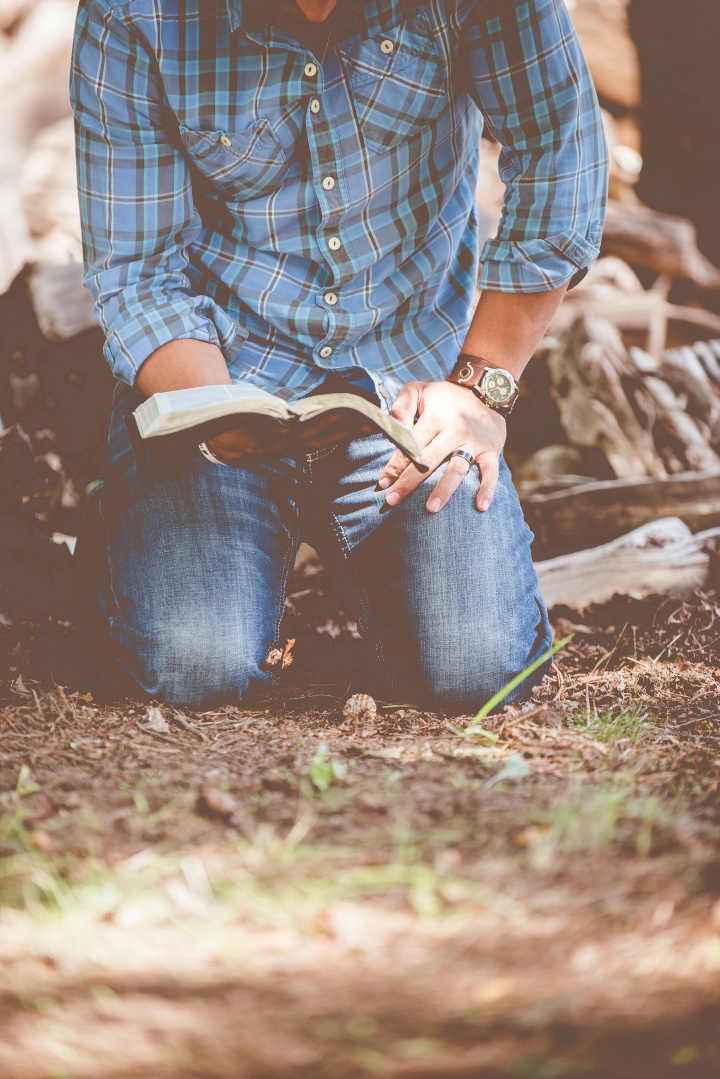 Man kneeling with Bible