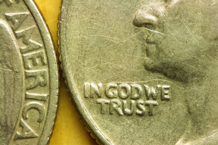 Close up of United States quarter displaying the phrase "In God We Trust".