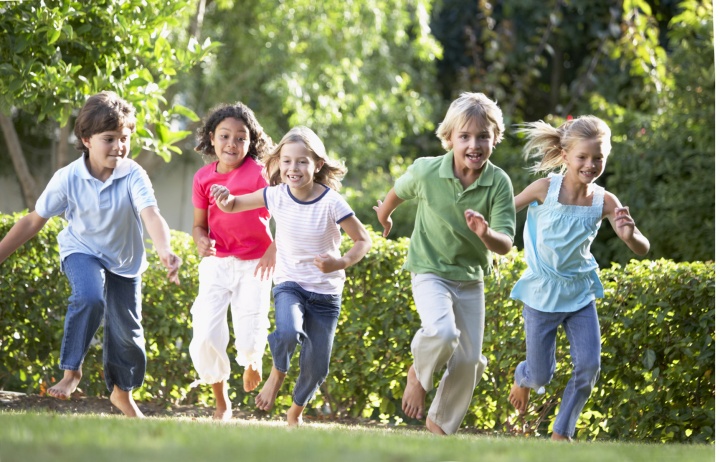 A group of young kids running.