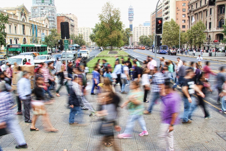 A blur of people walking in a busy city.