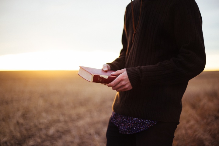 A man holding a Bible.