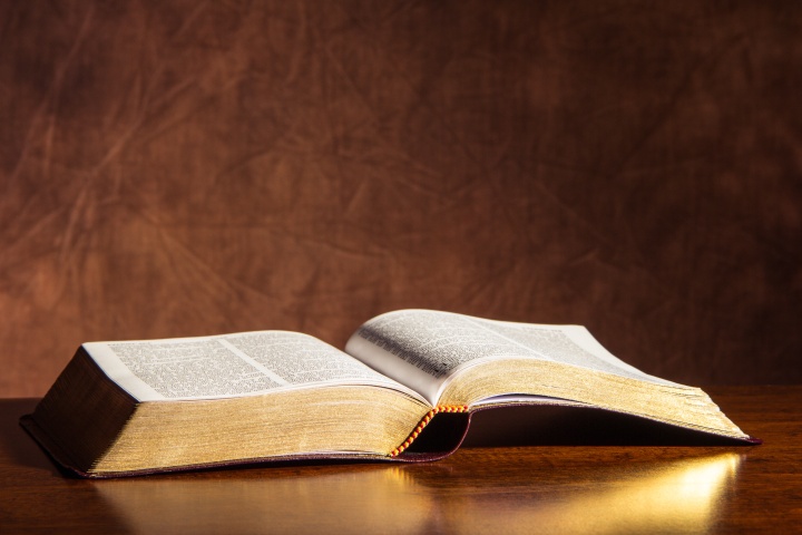 An open Bible on a table.