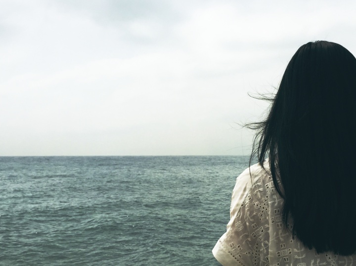 A woman looking out over a body of water.