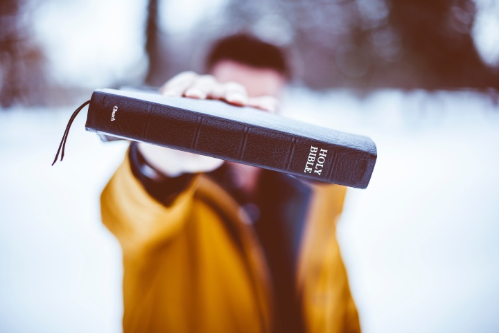 A man holding a Bible.