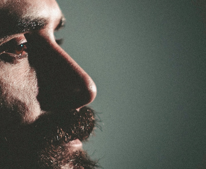 A up close photo of a man's face and beard.