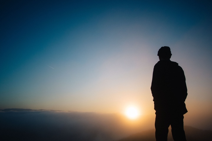 A person watching a sunset.