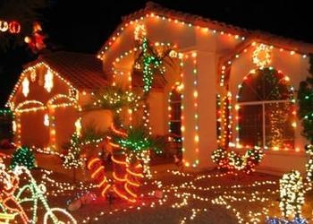 House lit up with lots of Christmas lights.