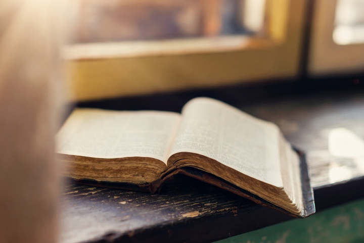 An open Bible on a windowsill.