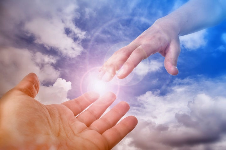 A photo illustration of hand coming out of the clouds.