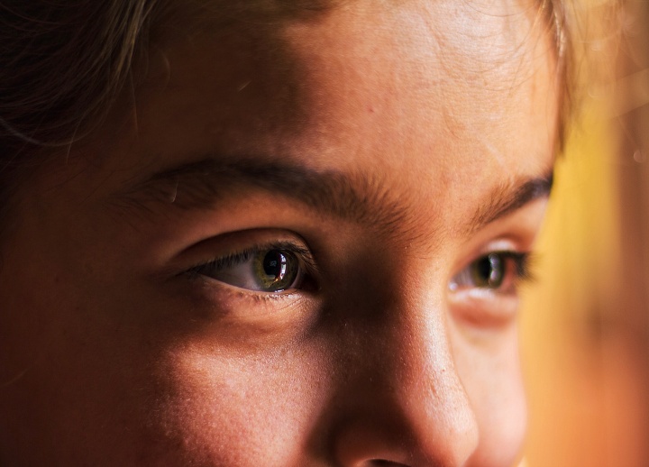 Upclose photo of young woman's face.