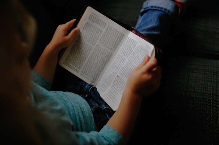 A person reading a Bible.