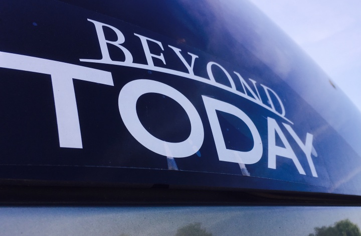 Beyond Today bumper sticker on a car window.