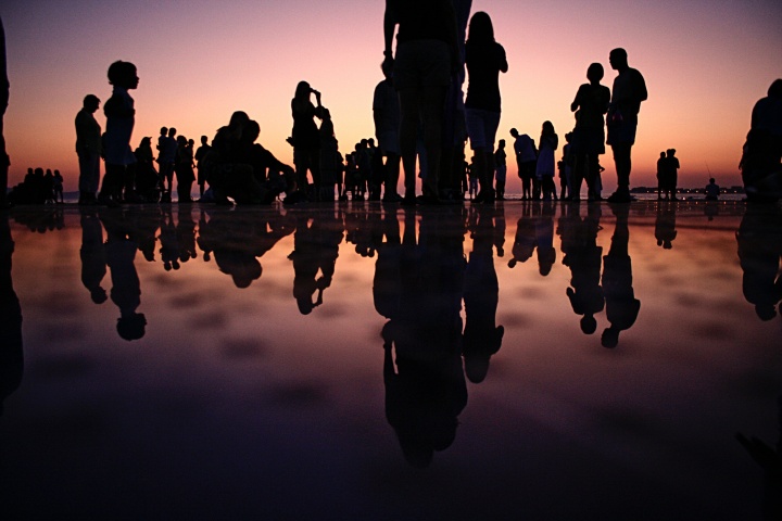 A group of people at sunset.