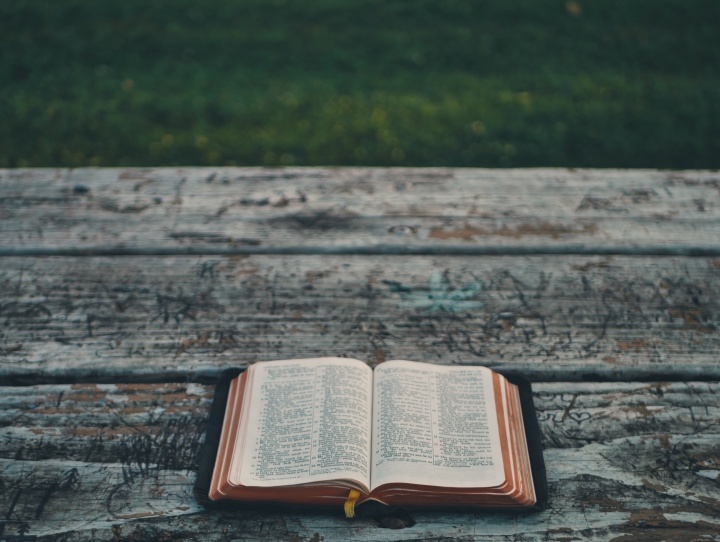 An open Bible laying on a table.